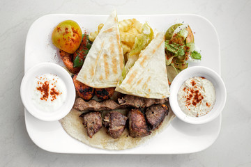 lebanese meshwi mixed grilled meat set on plate
