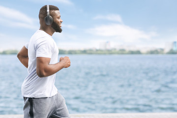 Smiling Black Man Jogging Outside Along River Bank