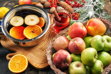 Christmas drink mulled wine, fruit and spices on a wooden table