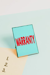 Writing note showing Warranty. Business concept for Free service of repair and maintenance of the...