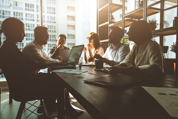 A team of young businessmen working and communicating together in an office. Corporate businessteam...