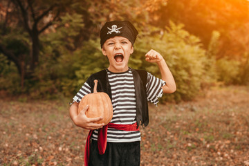 Excited pirate with pumpkin screaming in park