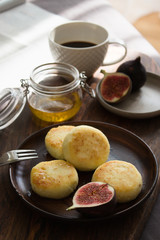 Syrniki for breakfast with honey and figs