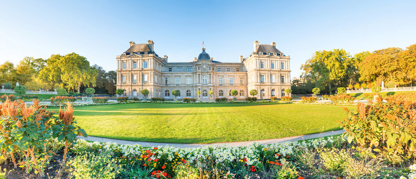 Panorama of Luxembourg garden with statues, flowers and building of Luxembourg Palace. Paris, France