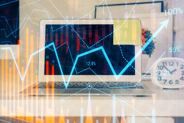 Forex market chart hologram and personal computer background. Multi exposure. Concept of investment.