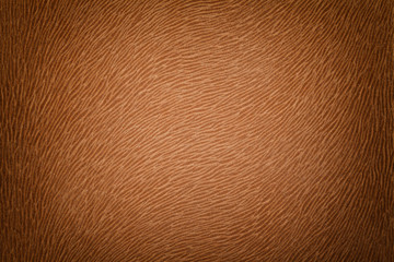 Dark brown matte background of suede fabric, closeup. Velvet texture.