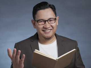 Young Man Reading Book, Smiling Expression