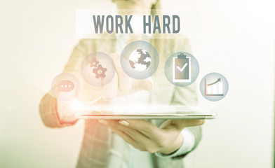 Conceptual hand writing showing Work Hard. Concept meaning Laboring that puts effort into doing and...