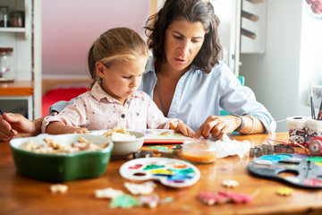 Fototapeta premium Mother learning her daughter to read 