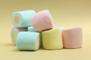 colorful marshmallows candy  on yellow background