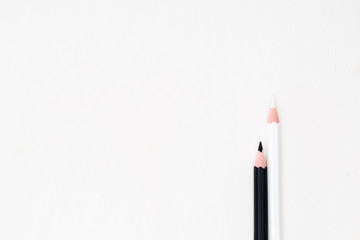 Education concept. White and black pencil on a white background.