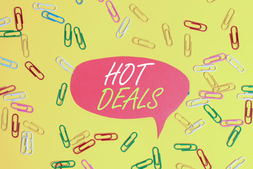 Handwriting text Hot Deals. Conceptual photo An agreement through which one of the paties is offered and accept Flat lay above empty paper with copy space and colored paper clips