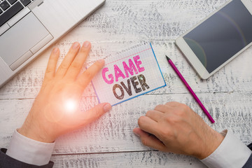 Conceptual hand writing showing Game Over. Concept meaning A situation in a particular sport that reach his finals or ending
