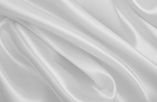 Smooth elegant white silk or satin luxury cloth texture as wedding background. Luxurious background design © Oxana Morozova