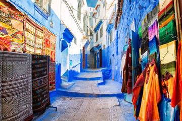 Traditional carpets on the blue Chefchaouen street.