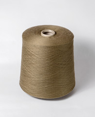 bobbin of yarn on a white background. Side view.Textile reel on isolated white background.