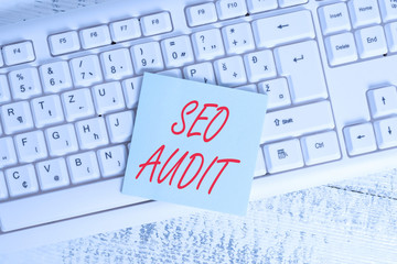 Conceptual hand writing showing Seo Audit. Concept meaning Search Engine Optimization validating and verifying process Keyboard office supplies rectangle shape paper reminder wood