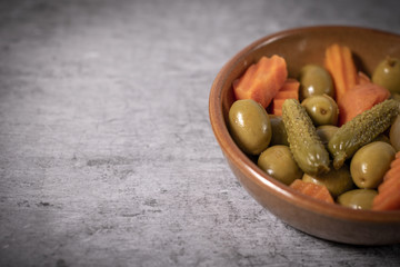 Pickles, carrots and olives in a bowl