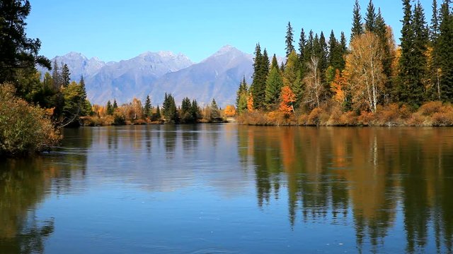 Beautiful autumnal landscape with the Eastern Sayan Mountains and the Irkut River at sunny day. Siberia,  Baikal region, Buryatia, Tunka Valley