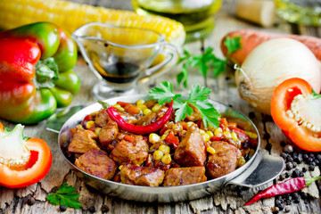 Meat stew with vegetables corn, pepper, onion, carrot in soy sauce gravy