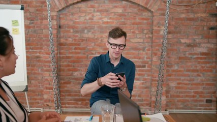 Business Man Team Leader or Trainer is Discussing Project to Employees in Startup Loft Office. Teamwork or Seminar in Diverse Group of People. Meeting at Work. 4K Gimbal Pull Out Shot in Slow Motion