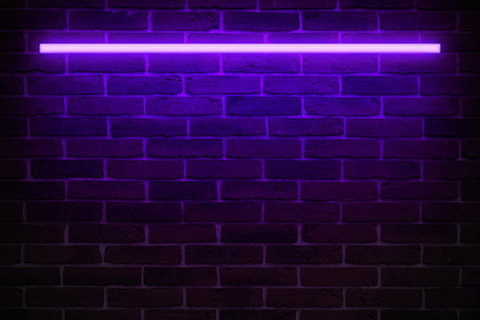 Background texture of empty red brick wall with violet neon light lamp, 80s style glow
