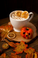 Warm cup of coffee with autumnal decor