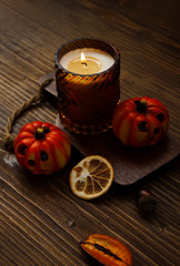 Moody view of candle with autumnal decor