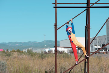 Fototapeta na wymiar scary clown on an abandoned billboard.