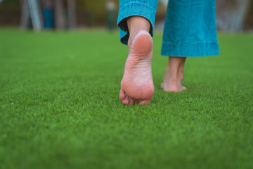 jeans barefoot walking on the grass