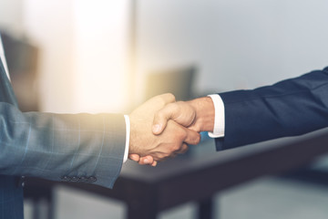 Two bussinesman shaking hands for their agreement of business 