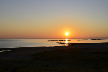 Sunrise with sun on the Adriatic Sea Italy