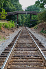Fototapeta na wymiar Wooden bridge over railroad tracks.