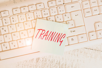 Conceptual hand writing showing Training. Concept meaning An activity occurred when starting a new job project or work Keyboard office supplies rectangle shape paper reminder wood