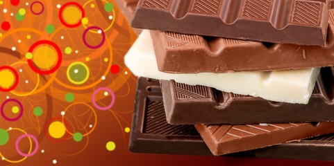 Pieces of delicious chocolate isolated on white