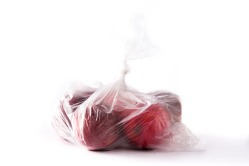 Red apples packaged in plastic bag isolated on white background