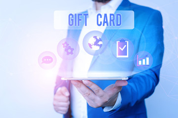 Text sign showing Gift Card. Business photo text A present usually made of paper that contains your message Male human wear formal work suit presenting presentation using smart device