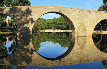 Old stone bridge over river in Spain