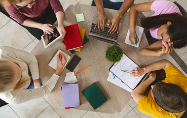 Group of international students sitting at table, top view