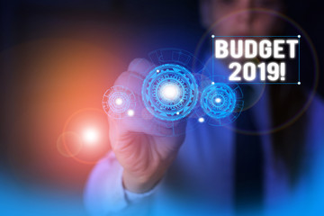 Text sign showing Budget 2019. Business photo showcasing estimate of income and expenditure for current year Woman wear formal work suit presenting presentation using smart device