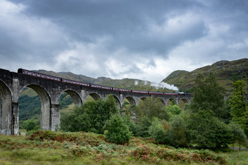 A steam train passing over Glenfinnan Viaduct, Scotland