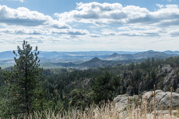 Blue skies over forested mountains