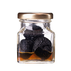 Canned black truffle isolated on a white background. Delicacy exclusive truffle mushroom. Piquant...