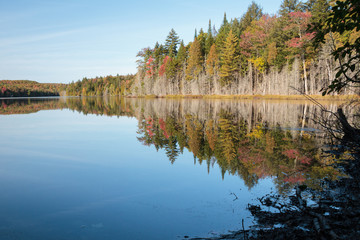 lake in autumn, reflection of trees in water, Portneuf area in province of Quebec, Canada
