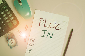 Writing note showing Plug In. Business concept for putting device into electricity to turn it on...