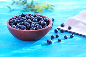 Blueberries in a wooden cup on the table. Berries and vitamins.