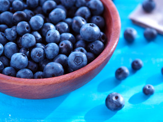 Blueberries in a wooden cup on the table. Berries and vitamins.