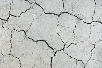 White dried and cracked ground. erosion earth background. cracked dry wall surface. white natural...