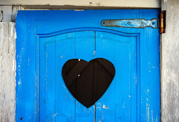 Old door of toilet with heart