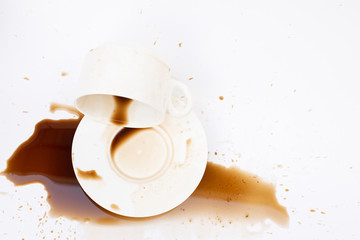 Top view, overturned beverage with spilled coffee on a white background